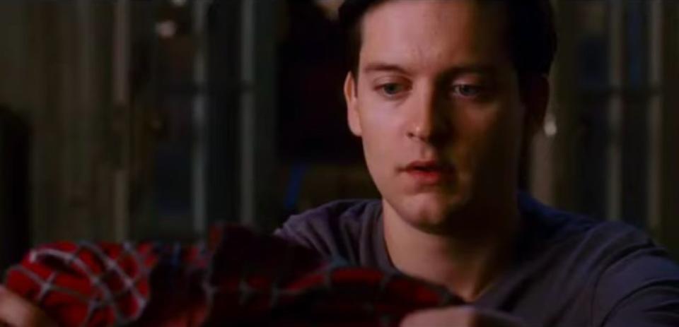 Peter holding his Spider-Man suit in his apartment in "Spider-Man 3"