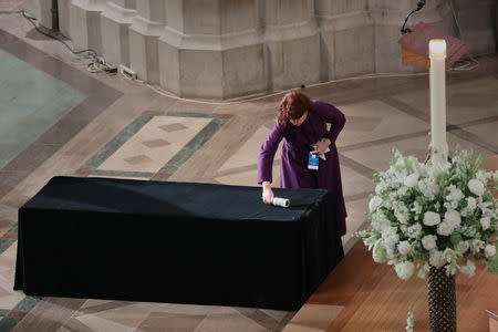 A woman prepares the bier before the funeral of U.S. Senator John McCain (R-AZ) at the National Cathedral in Washington, U.S., September 1, 2018. REUTERS/Chris Wattie