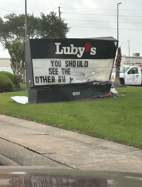 Damaged Luby's sign with humorous message, "You should see the other guy," implying a minor incident