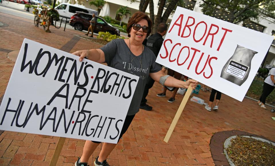 Lin Maloney of Osprey, believes in basic human rights. 'We Dissent' protest in downtown Sarasota had some 200 demonstrators that gathered at Selby Five Points Park and marched to the Judge Lynn N. Silvertooth Judicial Center, while braving rain and lightning.