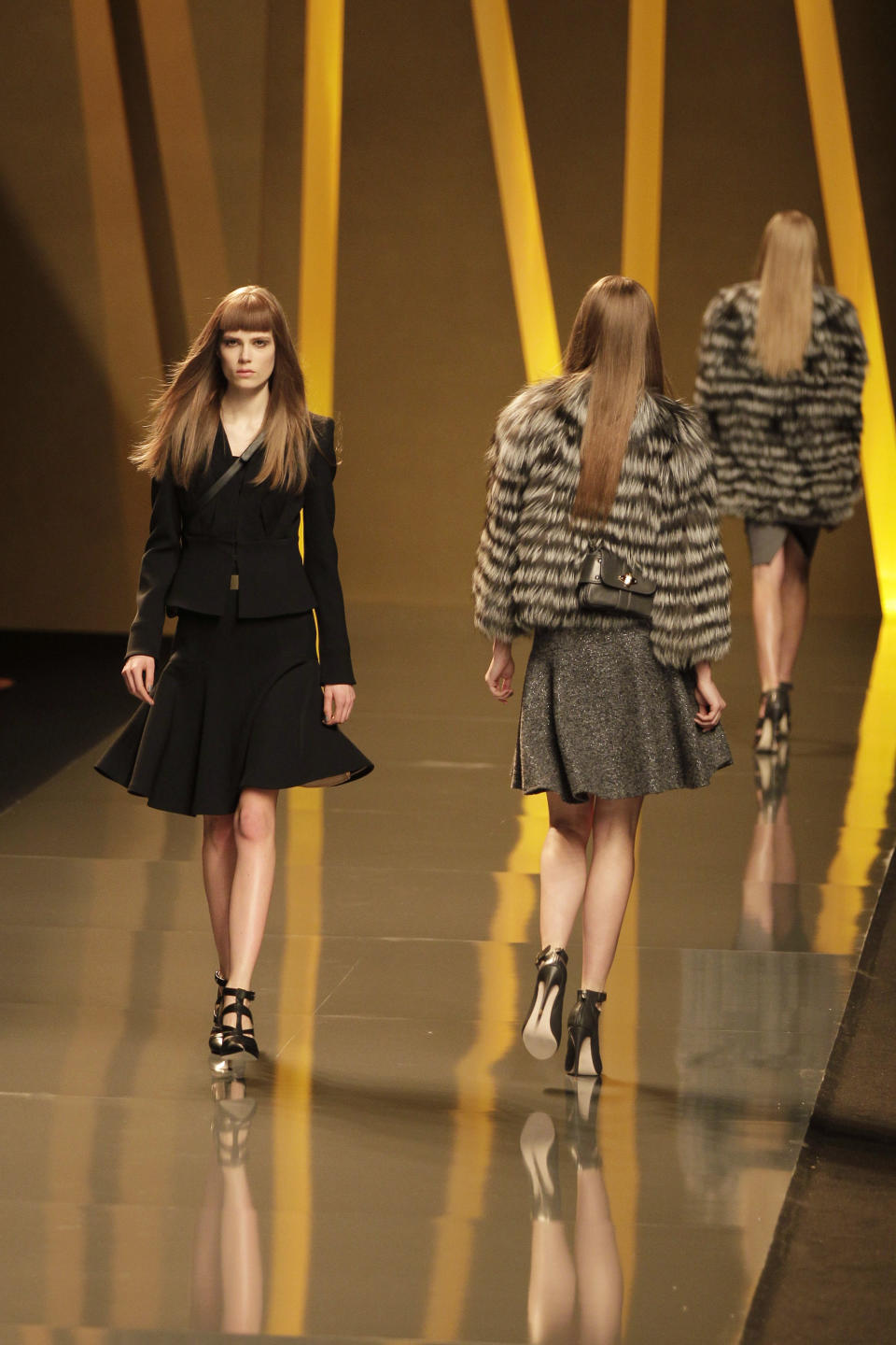 Models present creations by Lebanese designer Elie Saab as part of his Women's Fall-Winter, ready-to-wear 2013 fashion collection, during the Paris Fashion week, Wednesday, March 7, 2012. (AP Photo/Michel Euler)