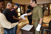 Security provide sanitizer to visitors at Jahangir art gallery in Mumbai.