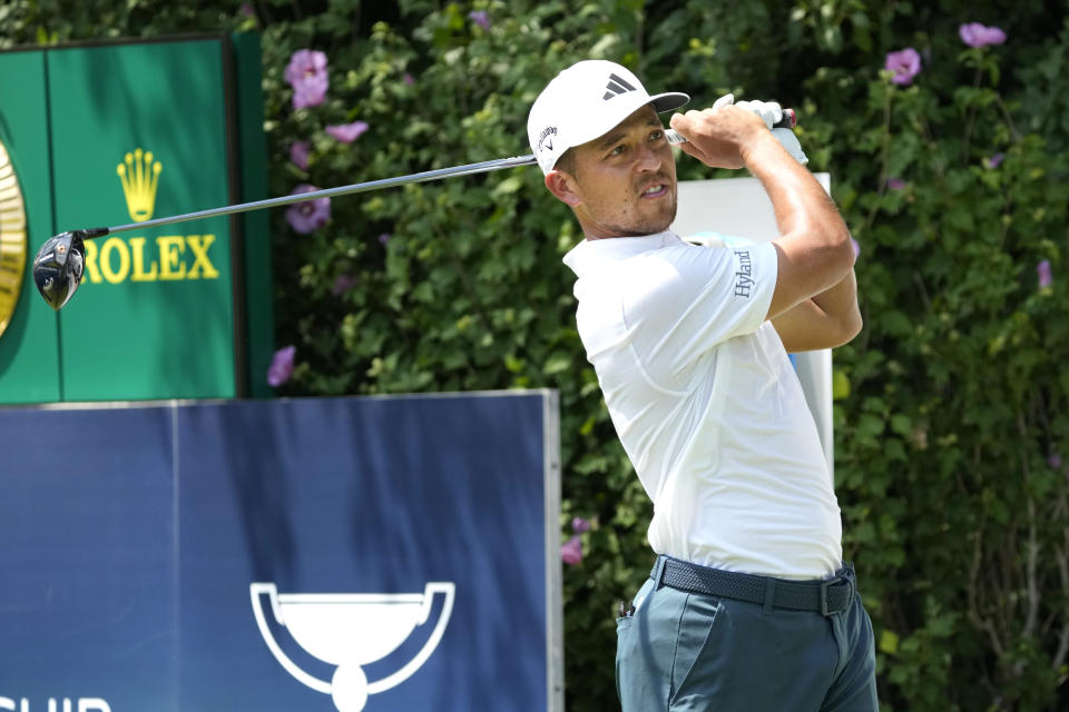 Xander Schauffele watches his tee shot on the first hole during the final round of the BMW Championship golf tournament, Sunday, Aug. 20, 2023, in Olympia Fields, Ill. (AP Photo/Charles Rex Arbogast)