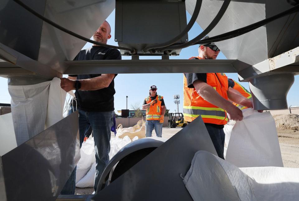 Volunteers assist in filling sandbags in Midvale on Friday, as part of a two-day plan of action preparing for the spring runoff.