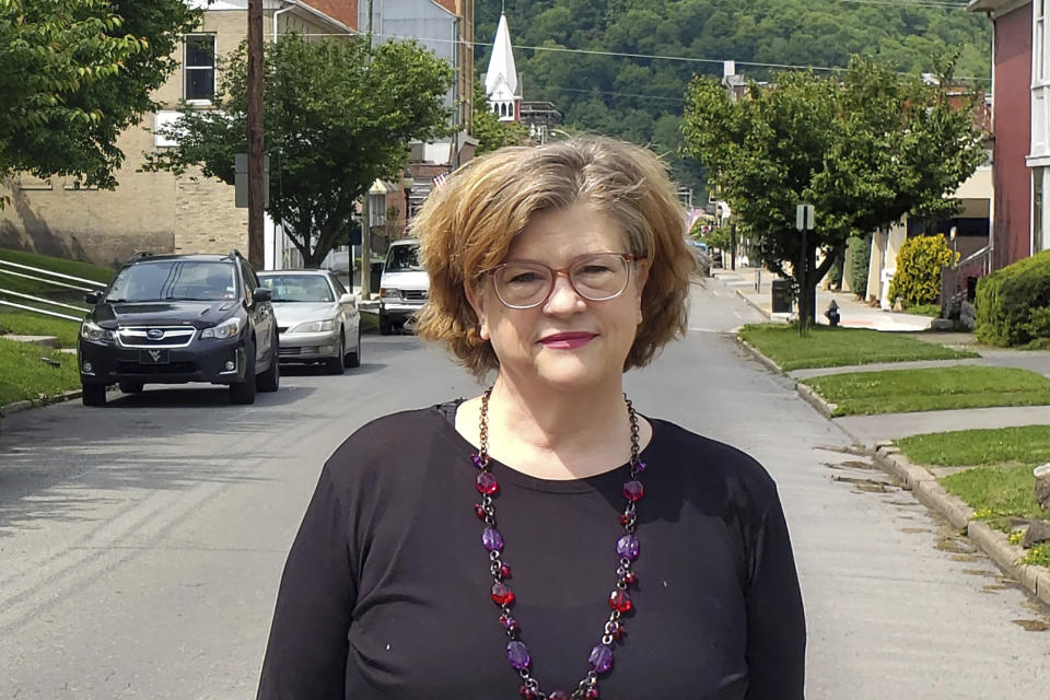 Susan Mazur-Stommen poses for a photo Tuesday, May 18, 2021, in her hometown of Hinton, W. Va. After her son went off to college, Mazur-Stommen was looking for an affordable place to retire. She moved to West Virginia in 2019 with her husband from Washington, D.C. (Ross Spiller via AP)