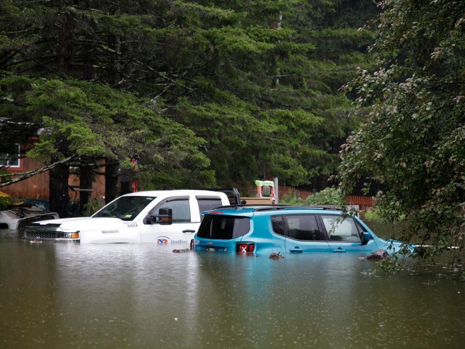 Floodwaters rise in Bridgewater, Vt., Monday, July 10, 2023, submerging parked vehicles and threatening homes near the Ottauquechee River. Heavy rain drenched part of the Northeast, washing out roads, forcing evacuations and halting some airline travel.