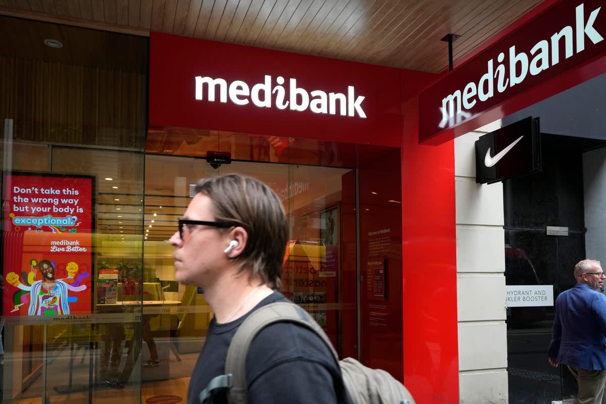 FILE - A man walks past a Medibank branch in Sydney.  (Associated Press)