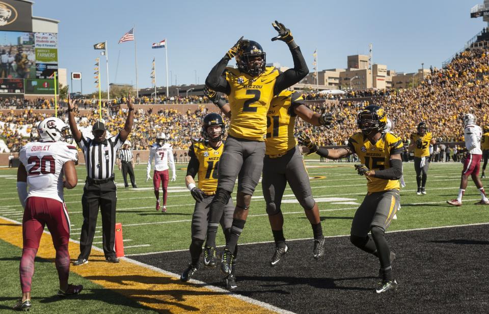 Missouri wide receiver Nate Brown, center, celebrates with teammates after he caught a touchdown pass over South Carolina safety T.J. Gurley, left, during the second quarter of an NCAA college football game Saturday, Oct. 3, 2015, in Columbia, Mo. (AP Photo/L.G. Patterson)