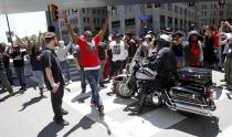 Protestors gather in a downtown intersection as Cleveland Police officers block them following the not guilty verdict for Cleveland police officer Michael Brelo on manslaughter charges in Cleveland, Ohio, in this file photo taken May 23, 2015. The city of Cleveland and the U.S. Justice Department reached a settlement on Tuesday to resolve allegations that the city's police use excessive force against its civilians, the police union Cleveland Police Patrolmen's Association said. (REUTERS/Aaron Josefczyk)