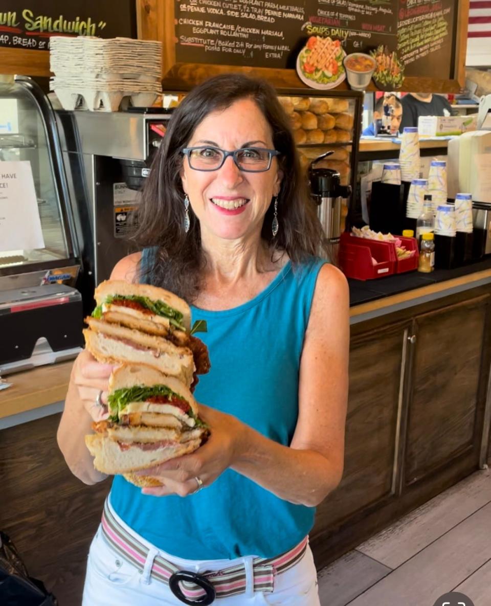 Lohud Food & Dining Reporter Jeanne Muchnick with  The Crooner (chicken cutlet, prosciutto de Parma, sundried tomato, arugula, fresh mozzarella, Balsamic glaze and herbed ricotta) at Leonardo's Italian Deli in New City. Photographed July 25, 2023