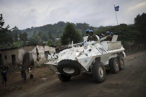 A United Nations armoured personnel carrier drives along the road between Goma and Rutshuru in the Democratic Republic of the Congo's North Kivu province in May 2012. UN and Democratic Republic of Congo troops are reinforcing Goma in the east of the country to guard against attack by rebels who have seized ground in recent days, UN officials said