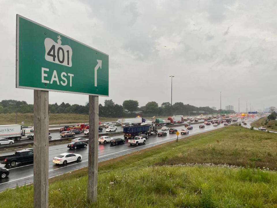 The collision happened in the eastbound collector lanes of Highway 401 early Tuesday, police say. A Toronto man has now been arrested and charged in the hit and run that left a highway maintenance worker with serious injuries. (Mehrdad Nazarahari/CBC - image credit)