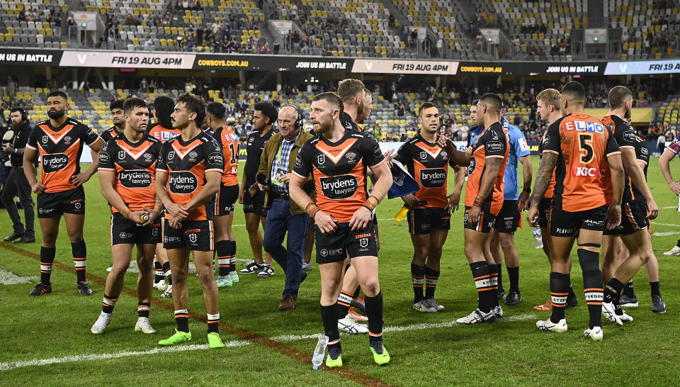 Wests Tigers players, pictured here looking dejected after their controversial loss to the Cowboys.