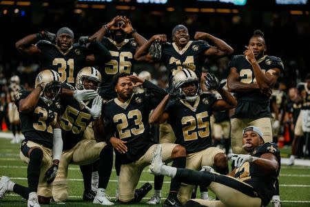 Aug 30, 2018; New Orleans, LA, USA; New Orleans Saints safety Chris Banjo (31) and linebacker Demario Davis (56) and cornerback Justin Hardee (34) and safety Vonn Bell (24) and cornerback Arthur Maulet (37) and linebacker Jayrone Elliott (55) and cornerback Marshon Lattimore (23) and cornerback Marcus Williams (25) and linebacker Craig Robertson (52) celebrate on the field after turnover by the Los Angeles Rams during the second half of a preseason game at the Mercedes-Benz Superdome. The Saints defeated the Rams 28-0. Mandatory Credit: Derick E. Hingle-USA TODAY Sports