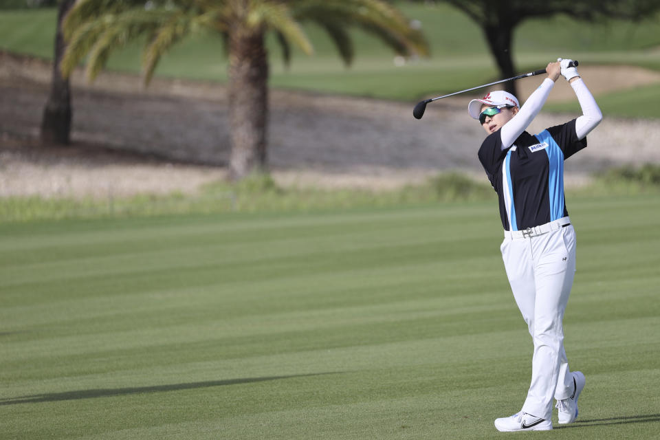 Hyo Joo Kim, of South Korea, watches her shot from the 11th fairway during the first round of the LPGA golf tournament Wednesday, April 12, 2023, near Honolulu. (AP Photo/Marco Garcia)