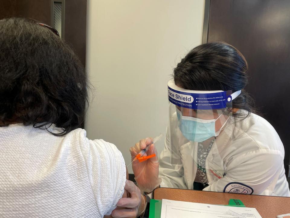 A patient is vaccinated against COVID-19 at a clinic run by Siloam Health in Tennessee.