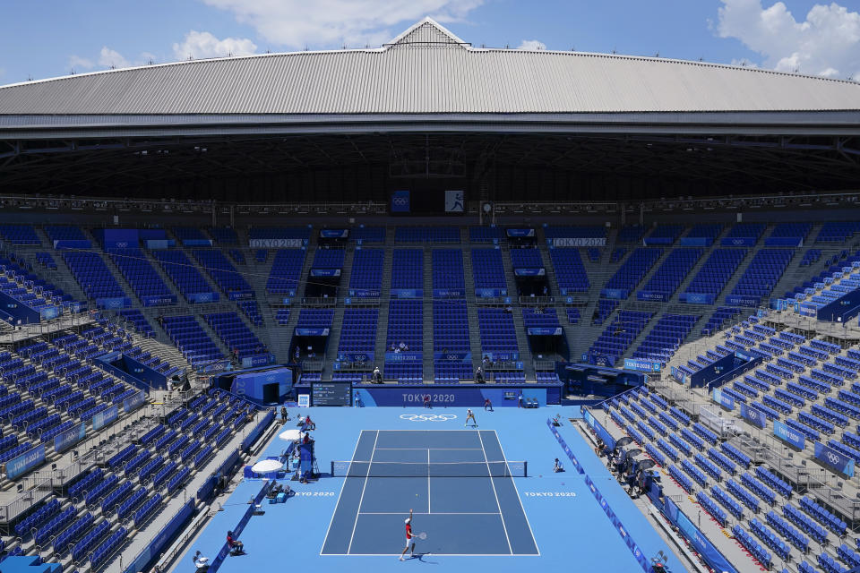 Daniil Medvedev, bottom, of the Russian Olympic Committee, serves to Alexander Bublik, of Kazakhstan, during the tennis competition at the 2020 Summer Olympics, Saturday, July 24, 2021, in Tokyo, Japan. (AP Photo/Patrick Semansky)