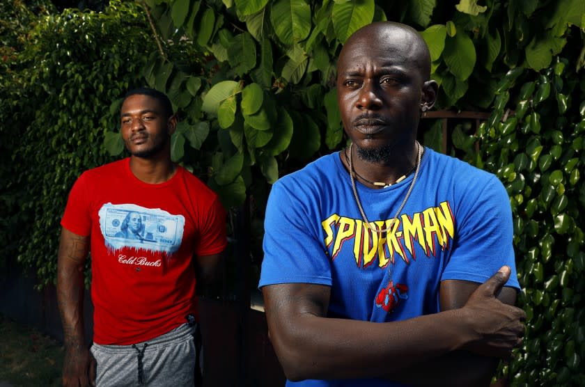 LOS ANGELES-AUGUST 24, 2020: Joshua McKinney, 26, left, and Eric Hunt, 41, are photographed at Joshua's grandmother's home in Los Angeles on Monday, August 24, 2020. The two are former inmate firefighters who want to go back to fighting fires, but can't because of legal barriers over their criminal records. (Christina House / Los Angeles Times)