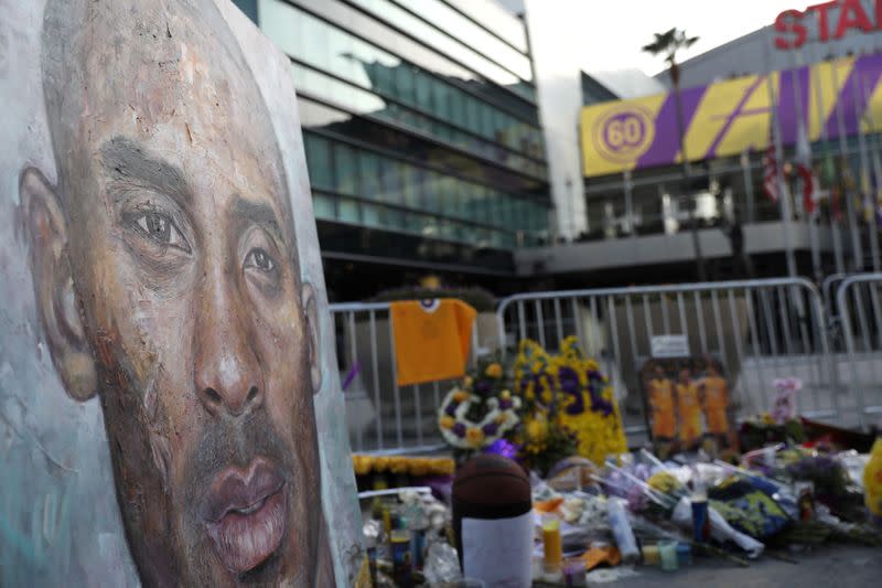 Floral and gift tributes lie outside Staples Center before a Los Angeles Lakers home game