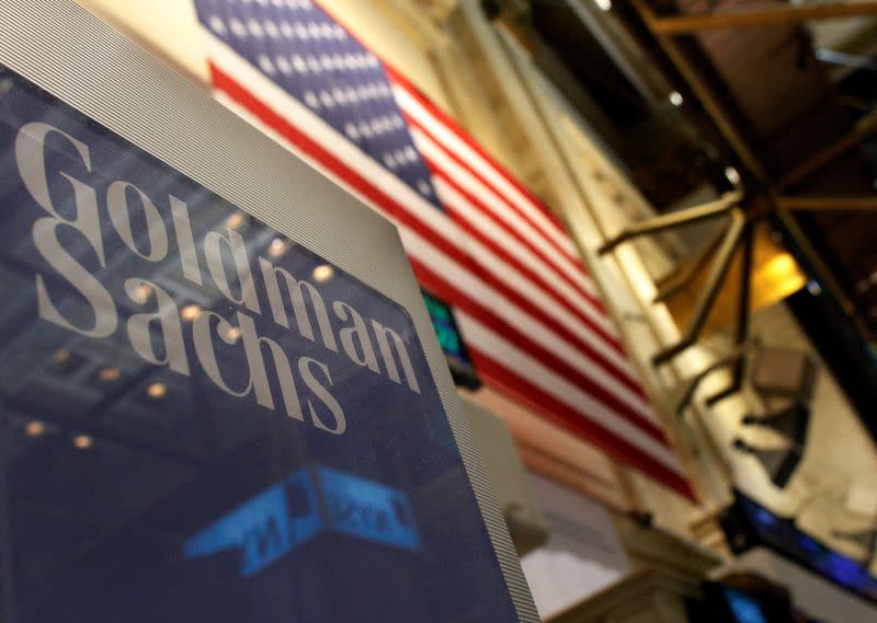 FILE PHOTO: A Goldman Sachs sign is seen above their booth on the floor of the New York Stock Exchange