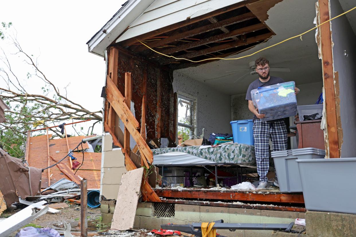 Sean Thomas Sledd salvages items from his room after it was hit by a tornado the night before in Sulphur, Okla., Sunday, April 28, 2024. Sledd sought shelter at Oklahoma School for the deaf.