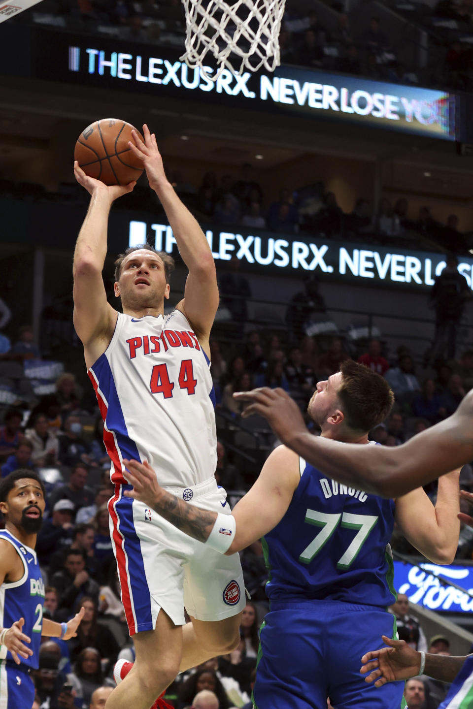 Detroit Pistons forward Bojan Bogdanovic (44) shoots over Dallas Mavericks guard Luka Doncic (77) in the first half of an NBA basketball game Monday, Jan. 30, 2023, in Dallas. (AP Photo/Richard W. Rodriguez)