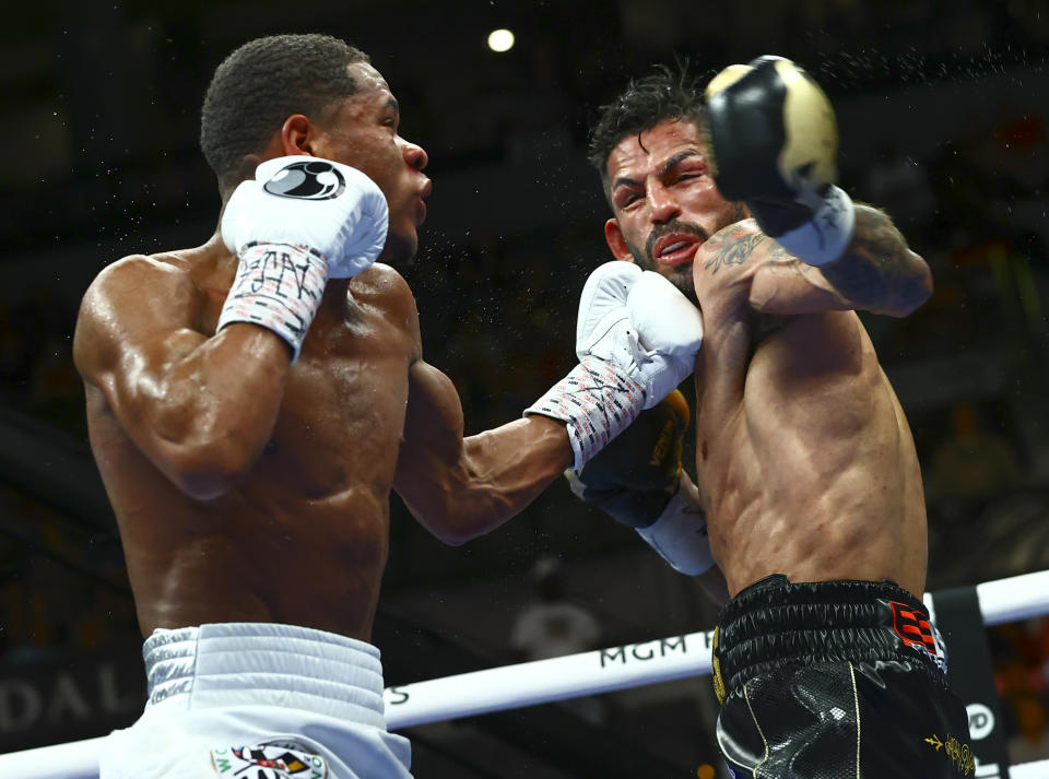 Devin Haney, left, punches Jorge Linares during the WBC lightweight title boxing match Saturday, May 29, 2021, in Las Vegas. (AP Photo/Chase Stevens)
