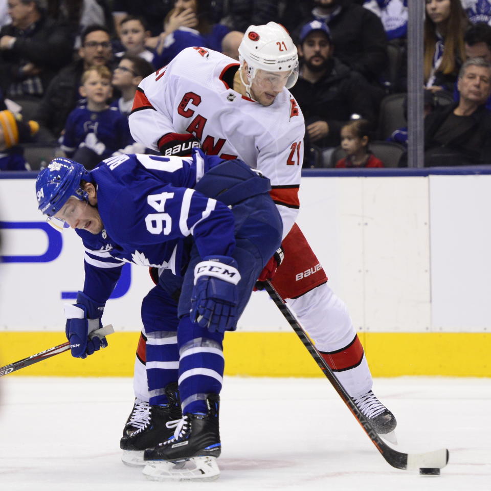 Toronto Maple Leafs defenceman Tyson Barrie (94) checks Carolina Hurricanes right wing Nino Niederreiter (21) during first period NHL hockey action in Toronto, Monday, Dec. 23, 2019. (Frank Gunn/The Canadian Press via AP)