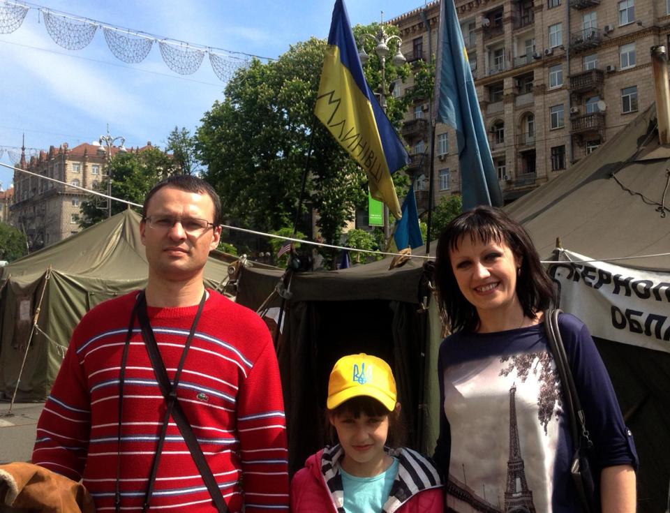 Andriy Poklonov, 35, his daughter Sofia, 8, and wife Evhenia, 35, pose for a photo in Kiev, Ukraine, Thursday, May 1, 2011. Despite the danger of war with Russia, the fear of losing more of their territory and tough economic times ahead, many Ukrainians in the center and west of the country are convinced that their country is moving in the right direction toward becoming a law-abiding European nation. (AP Photo/Maria Danilova)