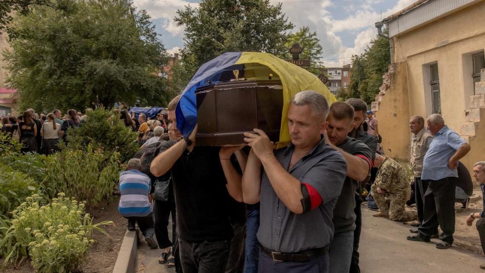 PHOTO: Men carry a coffin during the funeral of six Ukrainian servicemen, who were killed since Ukraine launched its offensive at the Russian border region of Kursk, in Sumy, northeastern Ukraine, on August 15, 2024.  (Roman Pilipey/AFP via Getty Images)