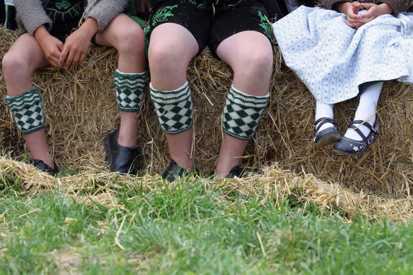 Children dressed in traditional Bavarian clothes attend the 5th ox-racing championships (5. Muensinger Ochsenrennen) on August 26, 2012 in Muensing, Germany. The competition, which only takes place once every four years, is a race of jockeys riding bareback on oxen across a field and is complemented with a morning procession and 'ox-ball' (featuring roasted ox) in a festivities tent after the races. (Photo by Johannes Simon/Getty Images)