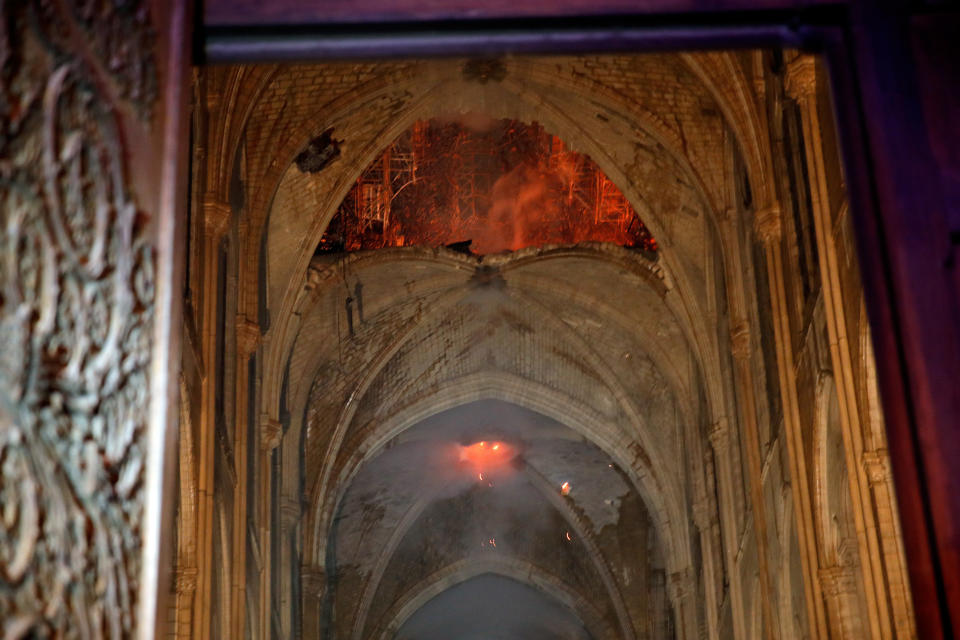 Flames and smoke are seen as the interior continues to burn inside the Notre Dame Cathedral in Paris, France, April 16, 2019.   REUTERS/Philippe Wojazer/Pool