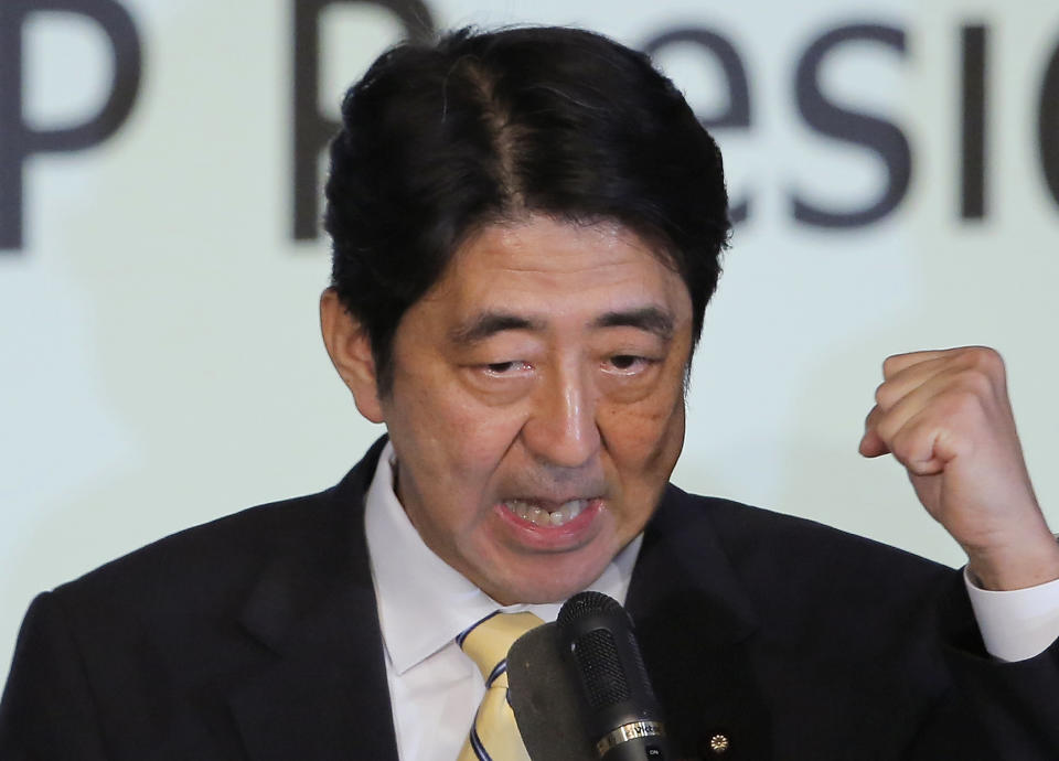 Former Prime Minister Shinzo Abe clenches his fist after winning the party leader election of Japan's Liberal Democratic Party in Tokyo, Wednesday, Sept. 26, 2012. Abe, known as a hawk and nationalist, won the election Wednesday to become president of the main opposition Liberal Democratic Party. (AP Photo/Itsuo Inouye)