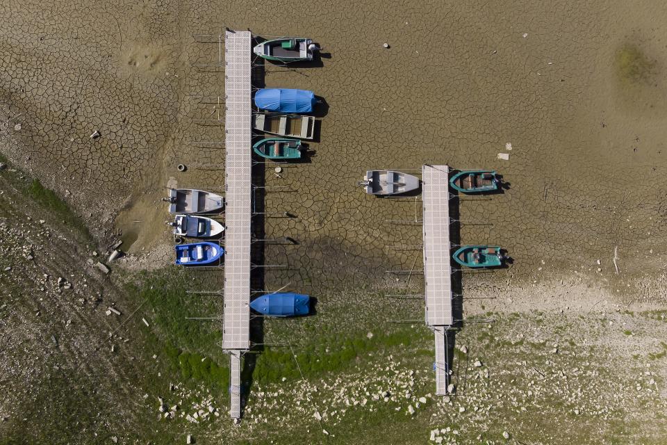 Stranded boats on the dried-out shore of Lac Brenet in Switzerland.