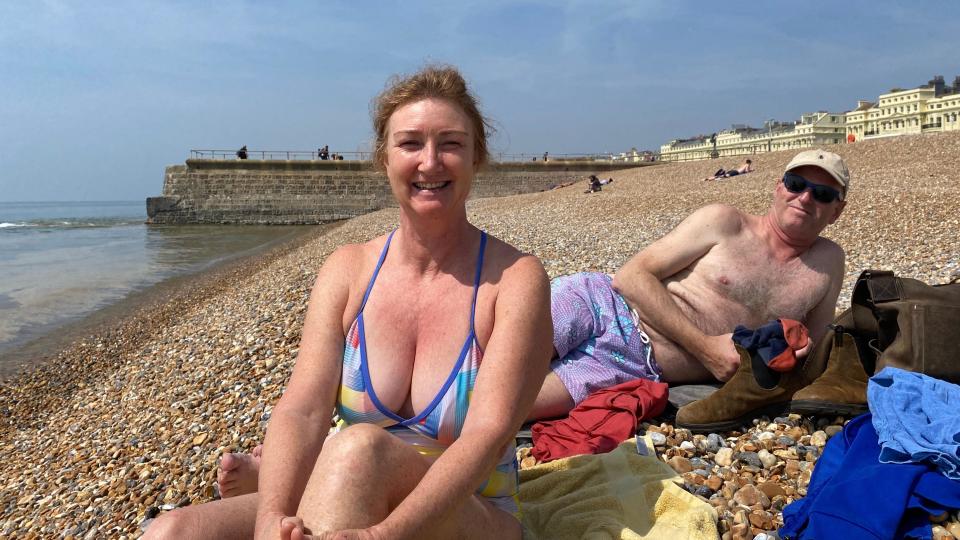 Two people in their swimming costumes on Brighton beach