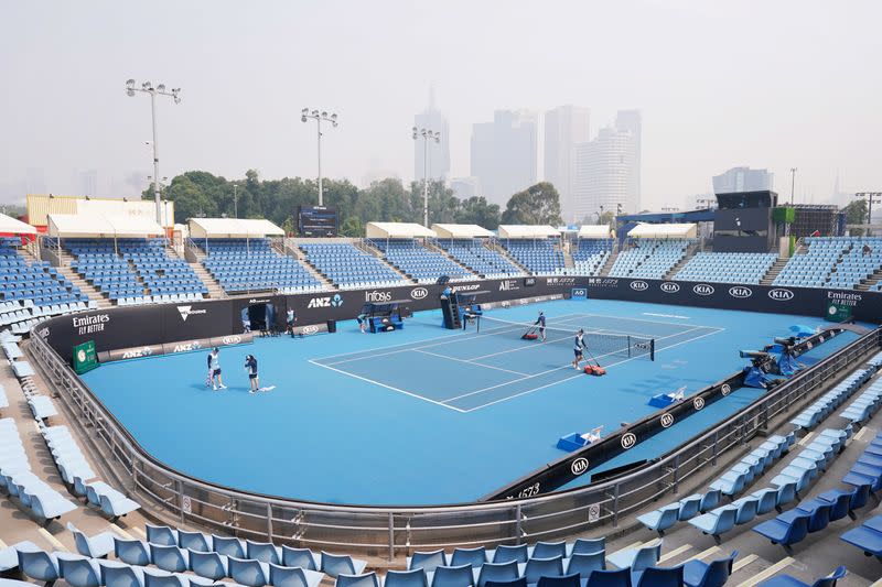 A general view is seen with the city skyline shrouded by smoke haze from bushfires during an Australian Open practice session at Melbourne Park in Melbourne