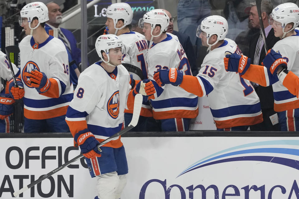 New York Islanders defenseman Noah Dobson (8) is congratulated for his goal against the San Jose Sharks during the first period of an NHL hockey game in San Jose, Calif., Thursday, March 7, 2024. (AP Photo/Jeff Chiu)