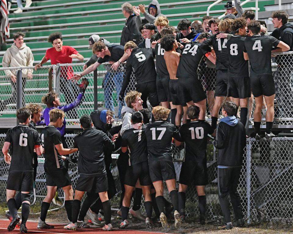 After a scoreless tie in regulation and two scoreless 10-minute overtime periods. the Lakewood Ranch High boys soccer team went on to win its Class 7A-Region 2 quarterfinal match against Orlando Olympia on penalty kicks, 5-3. Here the team celebrates with the fans after the win.