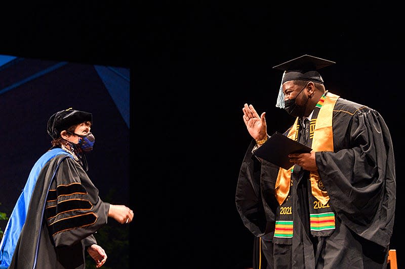 A Purdue University student celebrates onstage upon receiving his degree during the winter commencement ceremony on Dec. 18. More than 2,600 candidates received their Purdue degrees across three ceremonies over the weekend.