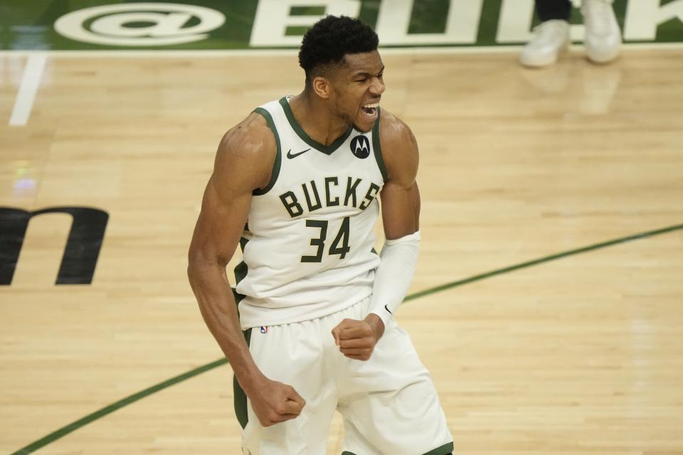 Milwaukee Bucks' Giannis Antetokounmpo reacts after teammate Khris Middleton made a three-point basket during the second half of Game 4 of the NBA Eastern Conference basketball semifinals game against the Brooklyn Nets Sunday, June 13, 2021, in Milwaukee. (AP Photo/Morry Gash)