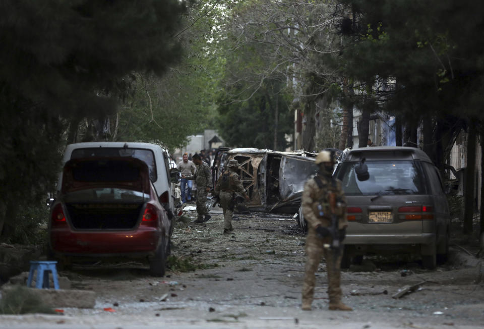 Afghan security forces guard the site of an explosion in Kabul, Afghanistan, Wednesday, May 8, 2019. The Taliban attacked the offices of an international NGO in the Afghan capital, setting off a huge explosion and battling Afghan security forces in an assault that killed at least five people, interior ministry said in a statement. The Ministry spokesman says over 20 Afghans were wounded in the attack. (AP Photo/Rahmat Gul)