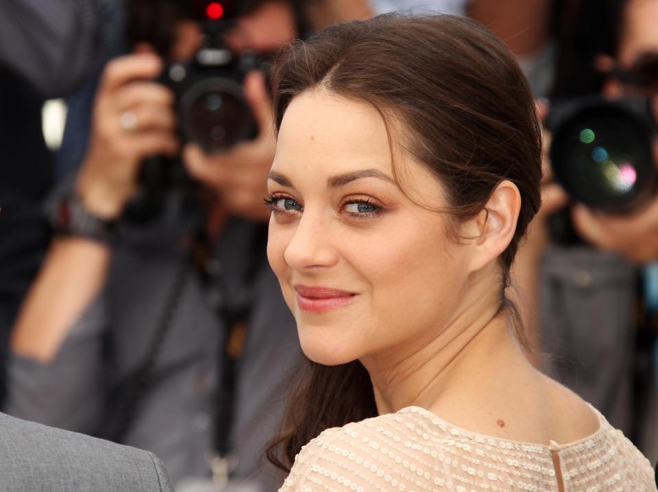 Actress Marion Cotillard poses during a photo call for Rust and Bone at the 65th international film festival, in Cannes, southern France, Thursday, May 17, 2012. (AP Photo/Joel Ryan)