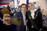 A new judge takes a photo with a relative during a swearing-in ceremony before Egypt’s State Council, in Cairo, Egypt, Tuesday, Oct. 19, 2021. Ninety eight women have become the first female judges to join the council, one of the country’s main judicial bodies. The swearing-in came months after President Abdel Fattah el-Sissi asked for women to join the State Council and the Public Prosecution, the two judicial bodies that until recently were exclusively male. (AP Photo/Tarek Wajeh)