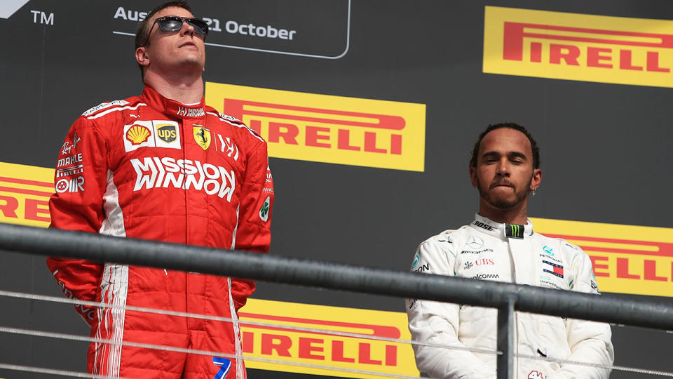 Kimi Raikkonen celebrates on the podium alongside Lewis Hamilton. (photo by Octane/Action Plus via Getty Images)