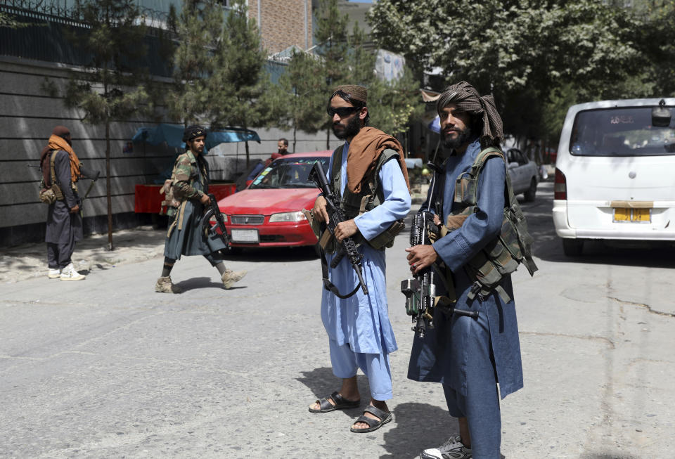 Taliban fighters stand guard at a checkpoint in the Wazir Akbar Khan neighborhood in the city of Kabul, Afghanistan, Wednesday, Aug. 18, 2021. The Taliban declared an "amnesty" across Afghanistan and urged women to join their government Tuesday, seeking to convince a wary population that they have changed a day after deadly chaos gripped the main airport as desperate crowds tried to flee the country. (AP Photo/Rahmat Gul)