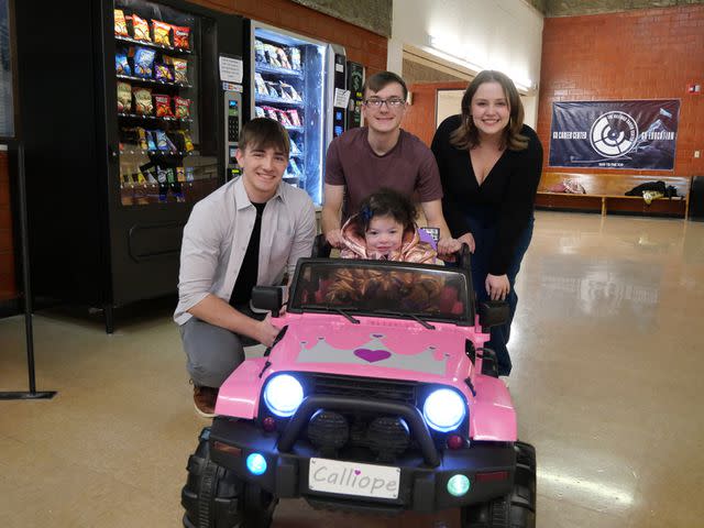 <p>Melanie Willardson</p> Billings Career Center students Kai Pohlman, Elijah McCoun and Ainsley Lennick (L-R) designed a special car for Calliope Lindau (seated)