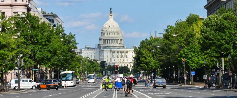 US Capitol building from Pennsylvania Avenue with car traffic foreground - Washington DC United States