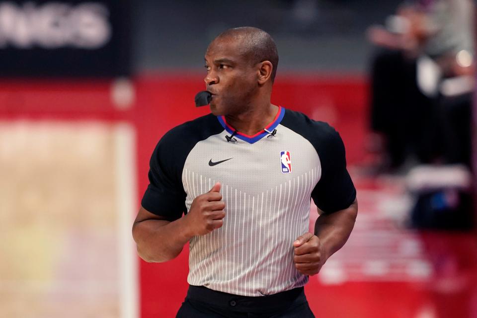 FILE - Referee Tony Brown runs on the sideline during the first half of an NBA basketball game between the Detroit Pistons and the Toronto Raptors, March 17, 2021, in Detroit. Brown, who was diagnosed with Stage 4 pancreatic cancer in April 2021, died Thursday, Oct. 20, 2022. He was 55. (AP Photo/Carlos Osorio, File)