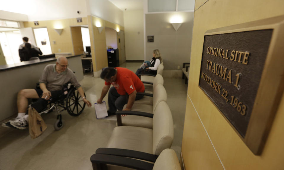 In this photo made Thursday, Nov. 7, 2013, a plaque marks the original site of Trama Room 1 where doctors rushed to treat the mortally wounded President John F. Kennedy at Parkland Memorial Hospital in Dallas. The Trauma Room 1 of Nov. 22, 1963, no longer exists and is now the radiology department at the hospital. (AP Photo/LM Otero)