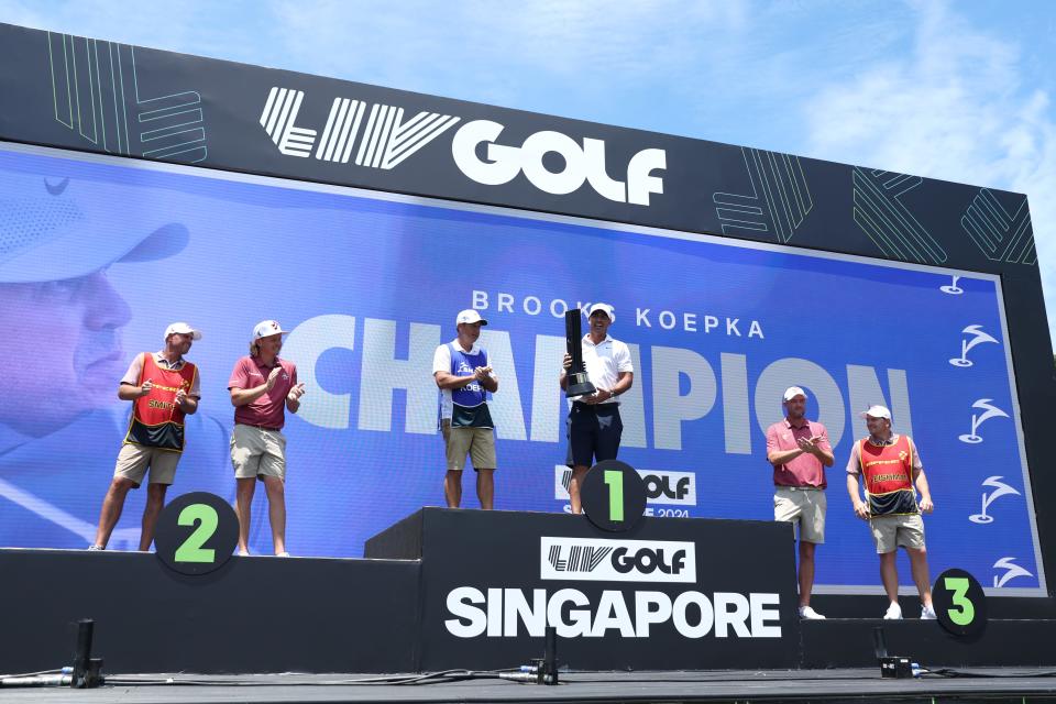 Brooks Koepka celebrates on the podium after winning the 2024 LIV Golf Singapore at Sentosa Golf Club. (Photo: Lionel Ng/Getty Images)